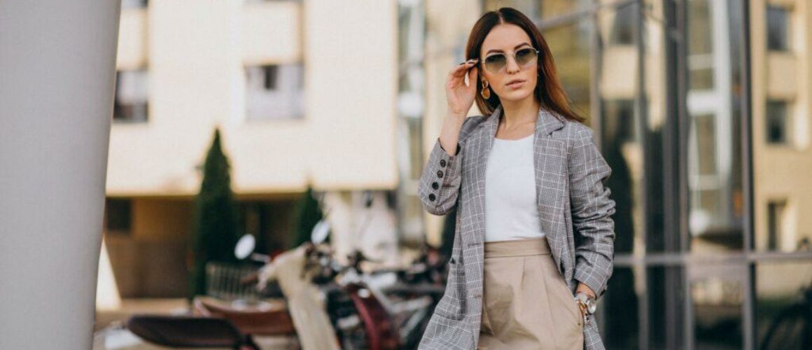 young-woman-suit-standing-by-scooter