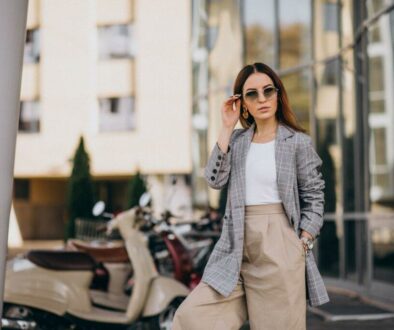 young-woman-suit-standing-by-scooter