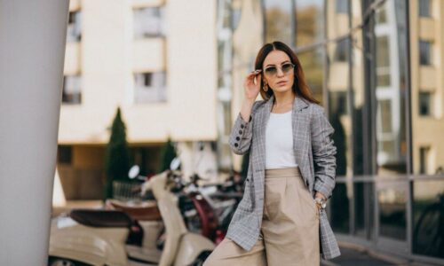 young-woman-suit-standing-by-scooter